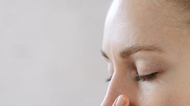 Close-up of a woman practicing mindful breathing, enhancing relaxation and wellness.