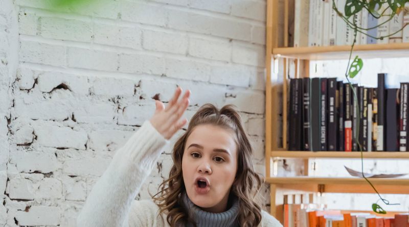 Annoyed woman emotionally shouting at husband and proving opinion to partner while man browsing laptop and ignoring