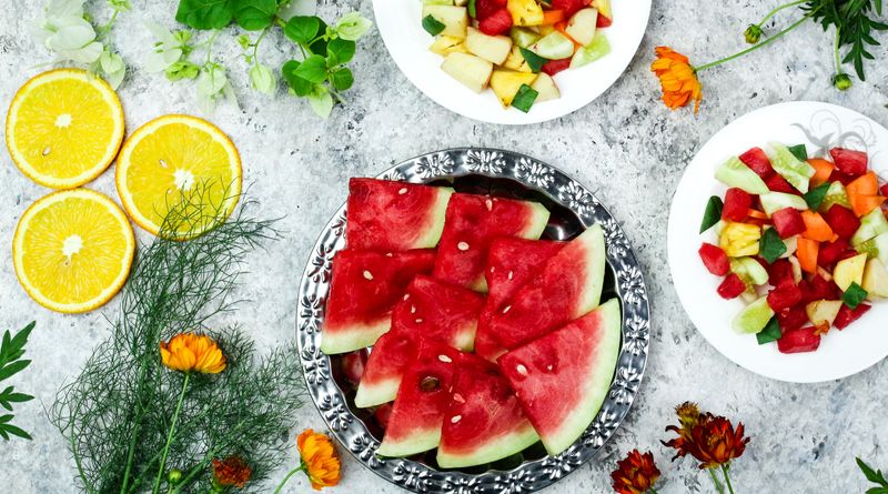 A colorful array of fresh fruit salad with watermelon and citrus, top view.