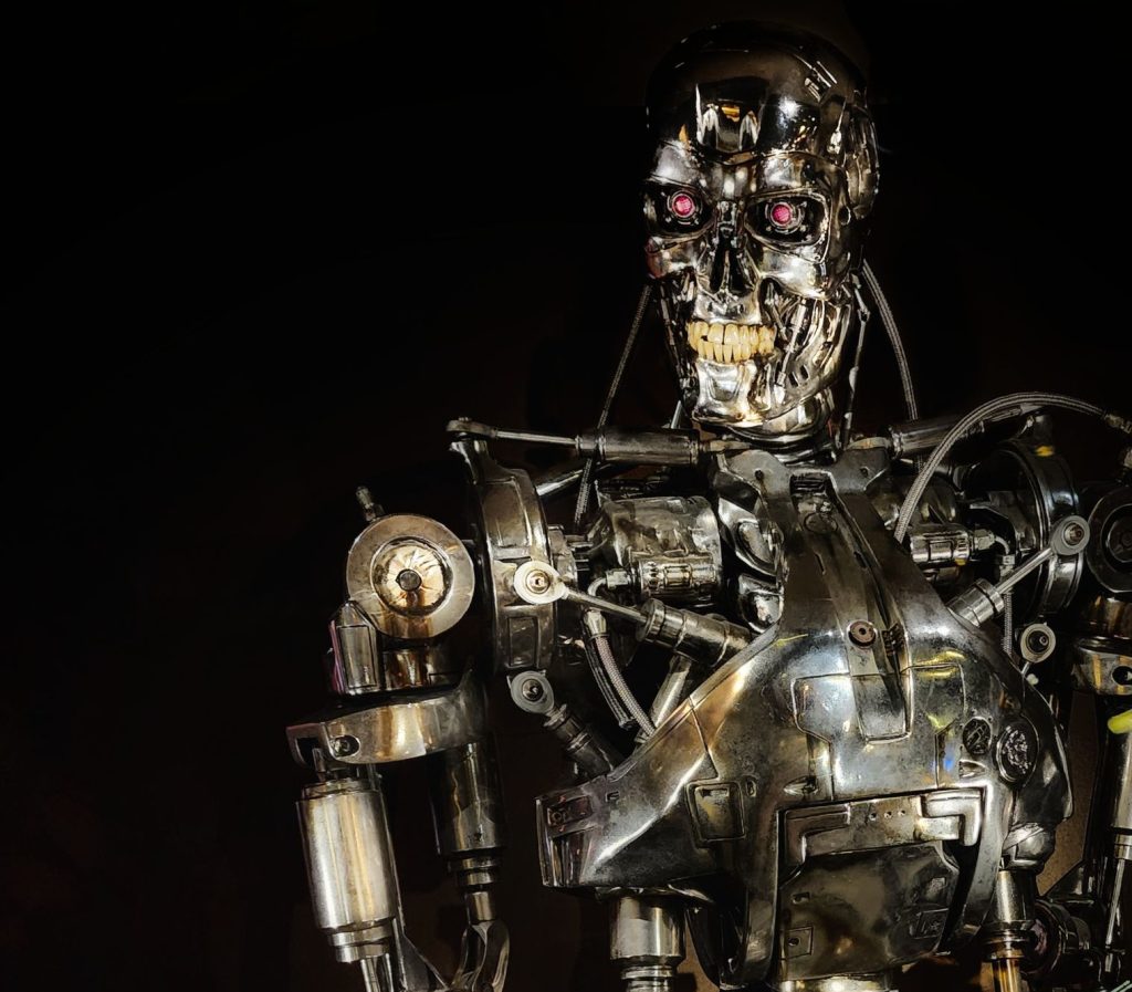 Close-up of a metallic robot showcasing intricate mechanical details in a dark setting.