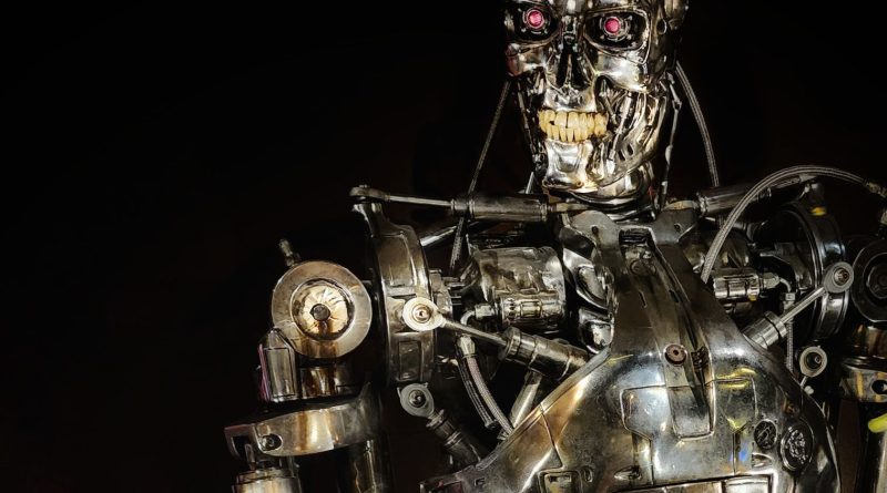 Close-up of a metallic robot showcasing intricate mechanical details in a dark setting.