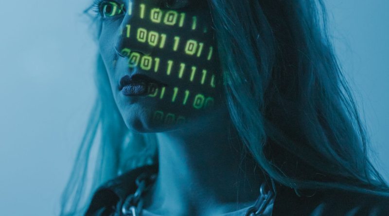 Stylized portrait of a woman with binary code projected on her face, evoking themes of technology and identity.